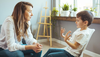 A school counsellor meets attentively with a student in a calm and welcoming school environment.