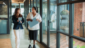 A school principal walks confidently through a school hallway, symbolising educational leadership and career growth.