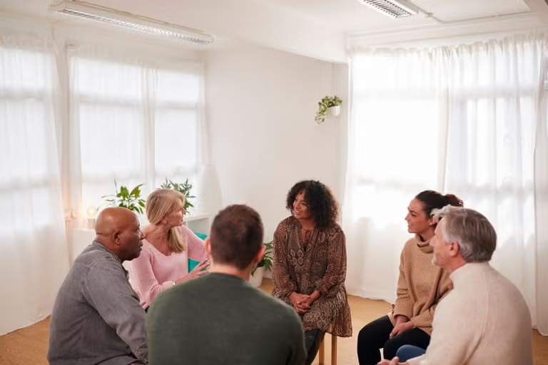A professional psychotherapist listens empathetically during a private therapy session.